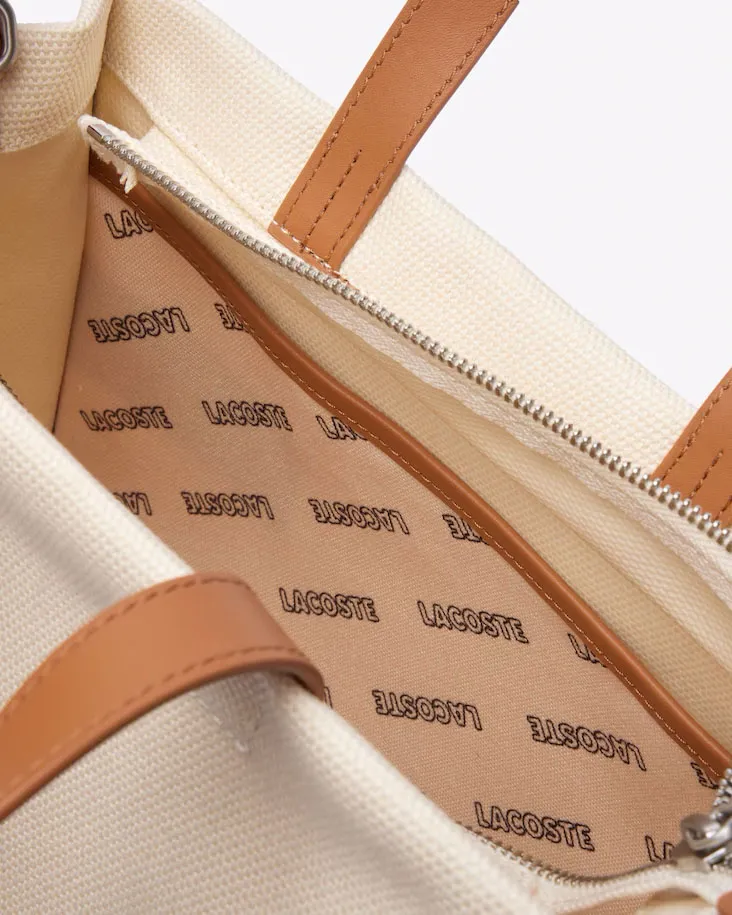 Borsa piccola a mano in canvass di cotone color naturale con scritta logo e profili in similpelle color cuoio