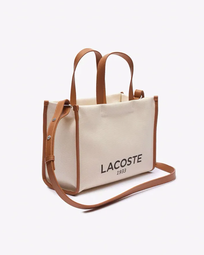 Borsa piccola a mano in canvass di cotone color naturale con scritta logo e profili in similpelle color cuoio