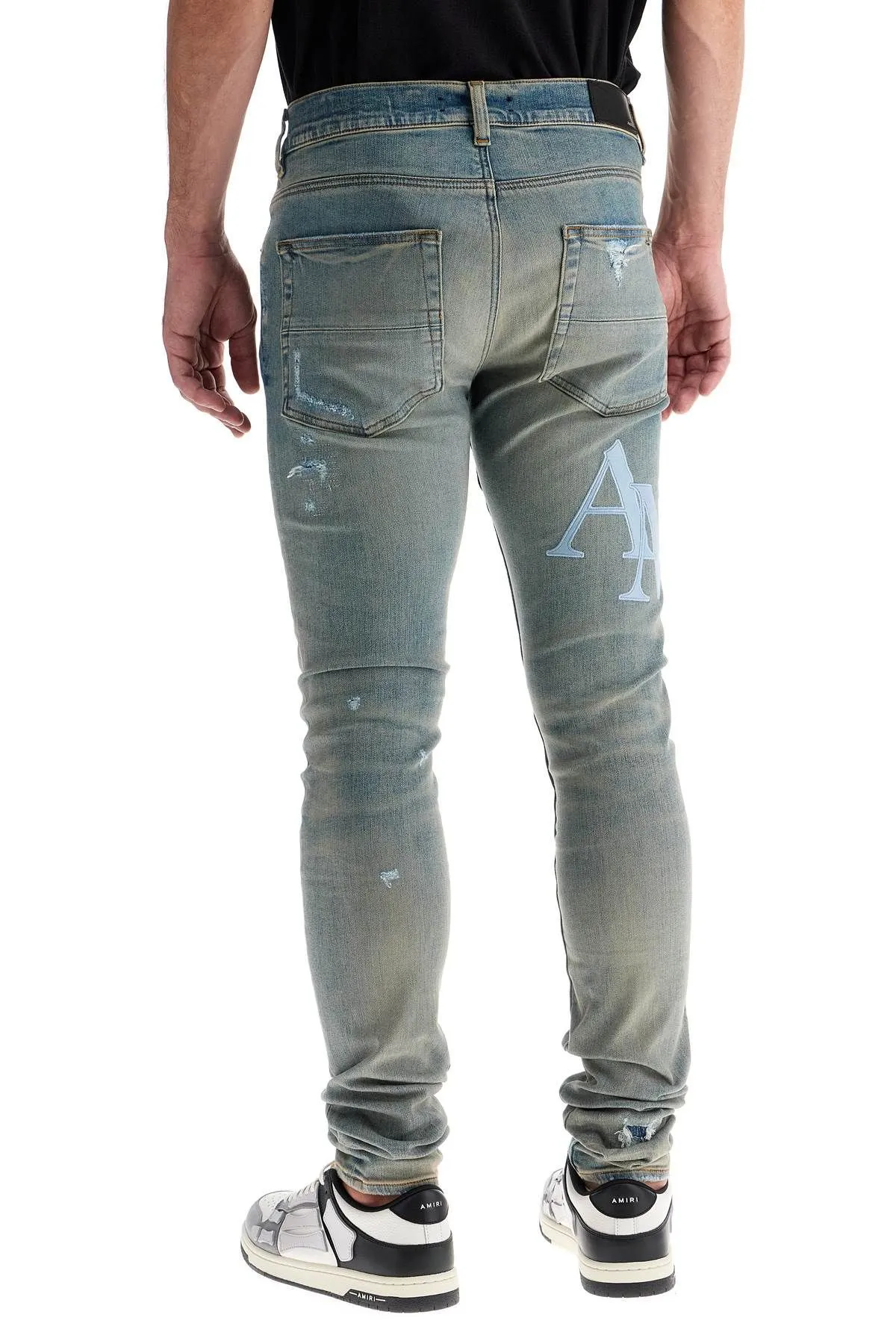 Jeans con logo in pelle